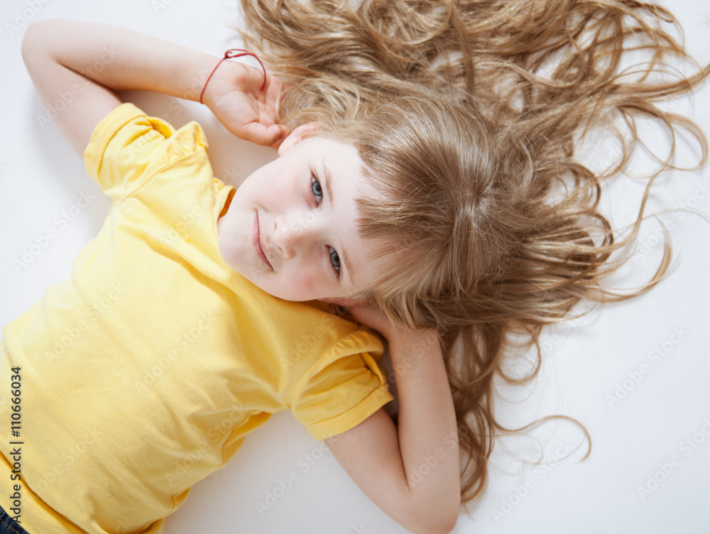 Portrait of a smiling girl lying on the floor Portrait of a smiling girl lying on the floor