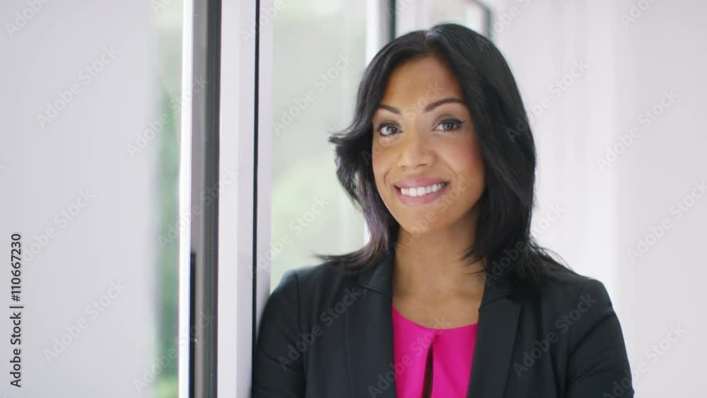  Portrait of attractive smiling businesswoman alone in office.