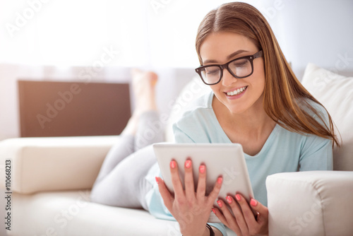 Positive woman resting on the couch 