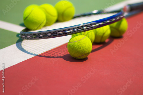 Tennis Ball with Racket on the clay tennis court © smolaw11