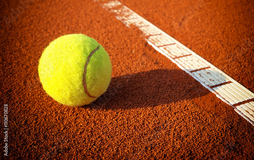 Tennis balls on a tennis clay court