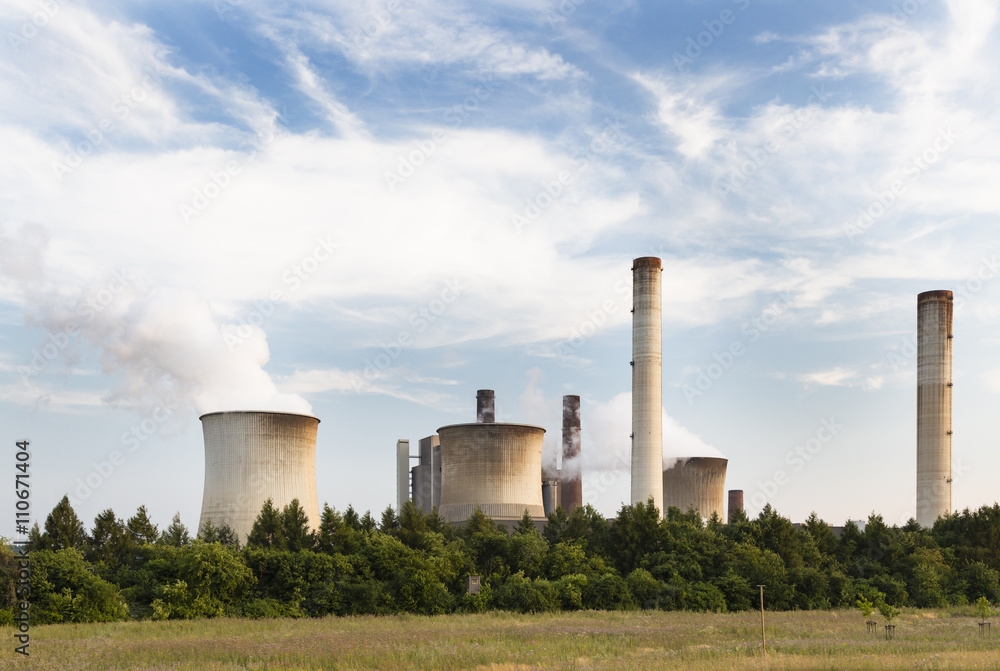 Power Plant Behind Field And Trees