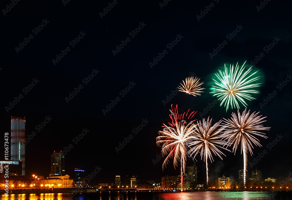 colored flashes of fireworks over the city pond of Yekaterinburg in the city center