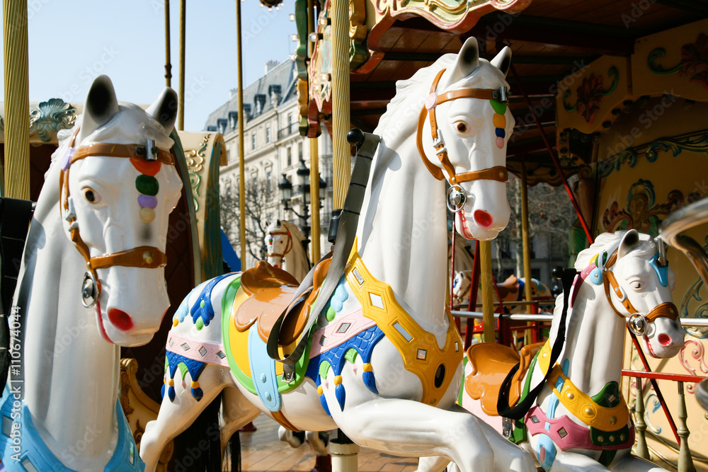detail of white horses and carriage in a carousel, roundabout or merry-go-round retro style