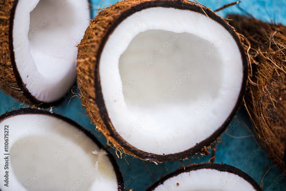 coconut halves on blue background coconut halves on blue background