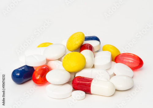 A variety of painkilling pills,tablets and drugs piled up on an isolated white background. photo