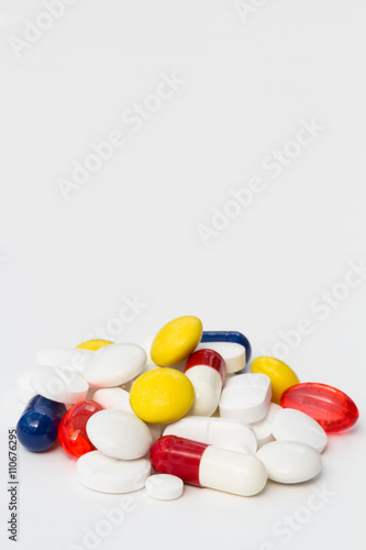A variety of painkilling pills,tablets and drugs piled up on an isolated white background.