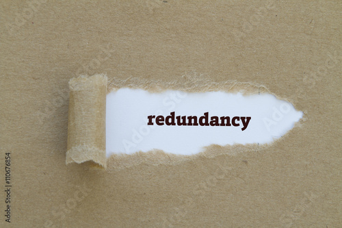 Foto Redundancy word written under torn paper.