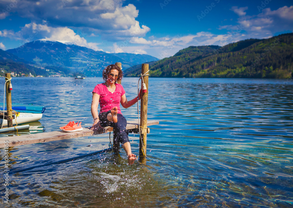 Naklejka premium woman resting from sports beside a lake-lake and bike 11