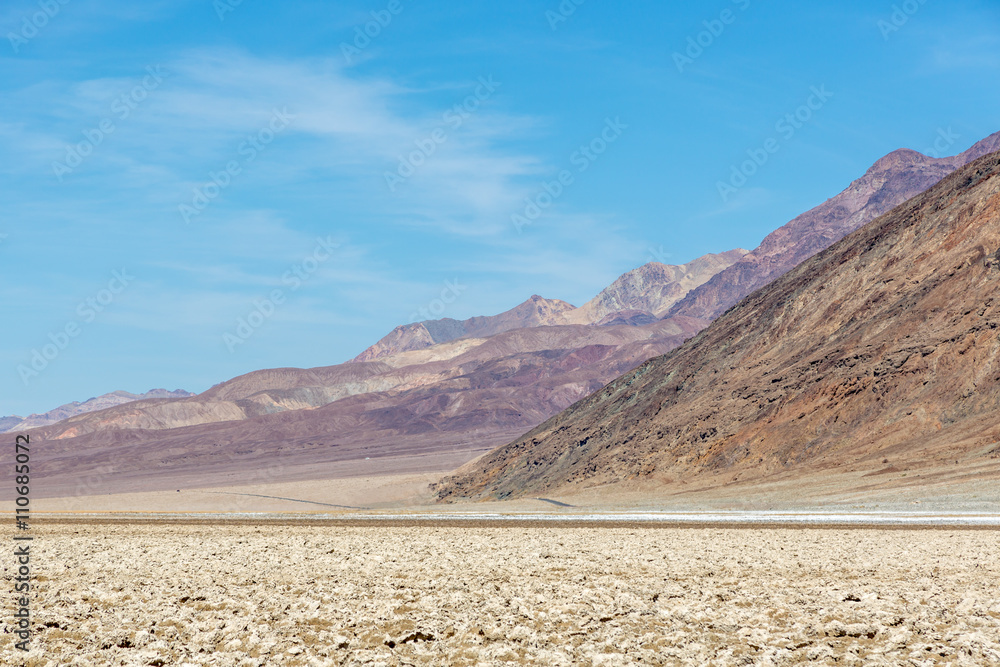 Beautiful scenario, sand formations in the foreground, blue sky day at the Death Valley National Park, Arizona, USA