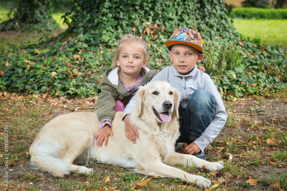 siblings with a golden retriever siblings with a golden retriever