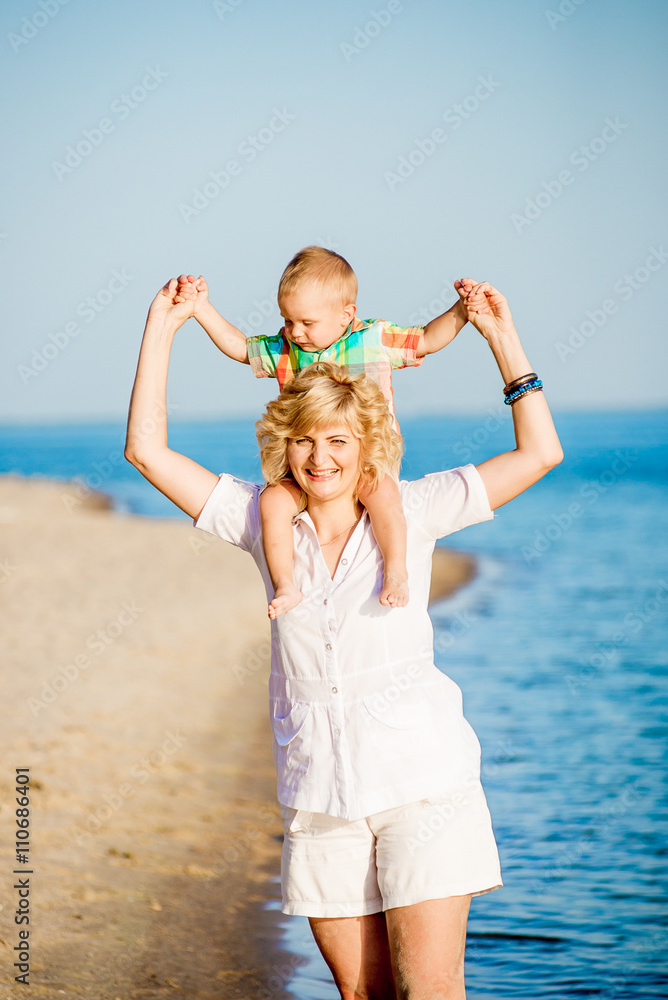 Mother with toddler walking on the beach. Mother with toddler walking on the beach.