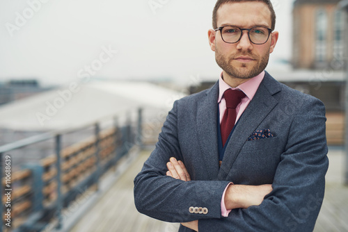 Fényképezés Stylish businessman standing outside near railing