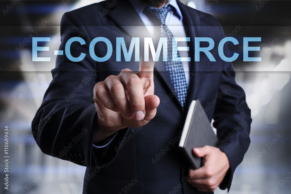 Businessman is pressing on virtual screen and selecting E-commerce. Businessman is pressing on virtual screen and selecting E-commerce.