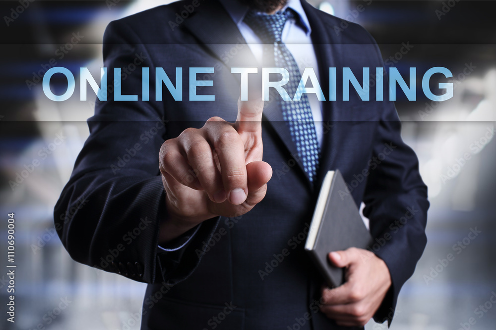Businessman is pressing on virtual screen and selecting Online training. Businessman is pressing on virtual screen and selecting Online training.