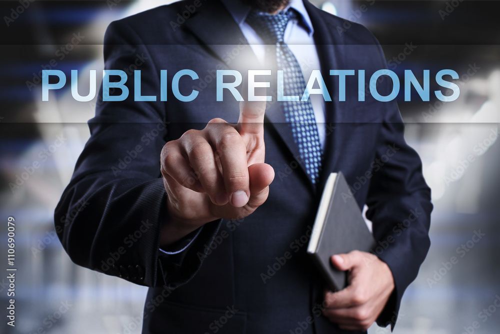 Businessman is pressing button on virtual screen and selecting Public Relations. Businessman is pressing button on virtual screen and selecting Public Relations.