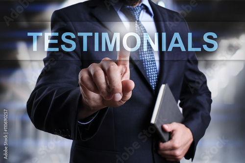Businessman is pressing button on virtual screen and selecting testimonials.