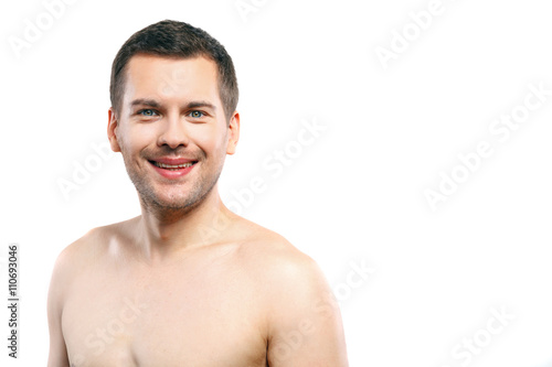 Cheerful young naked guy with happy smile
