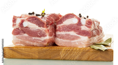Raw pork ribs with spices isolated on white. photo