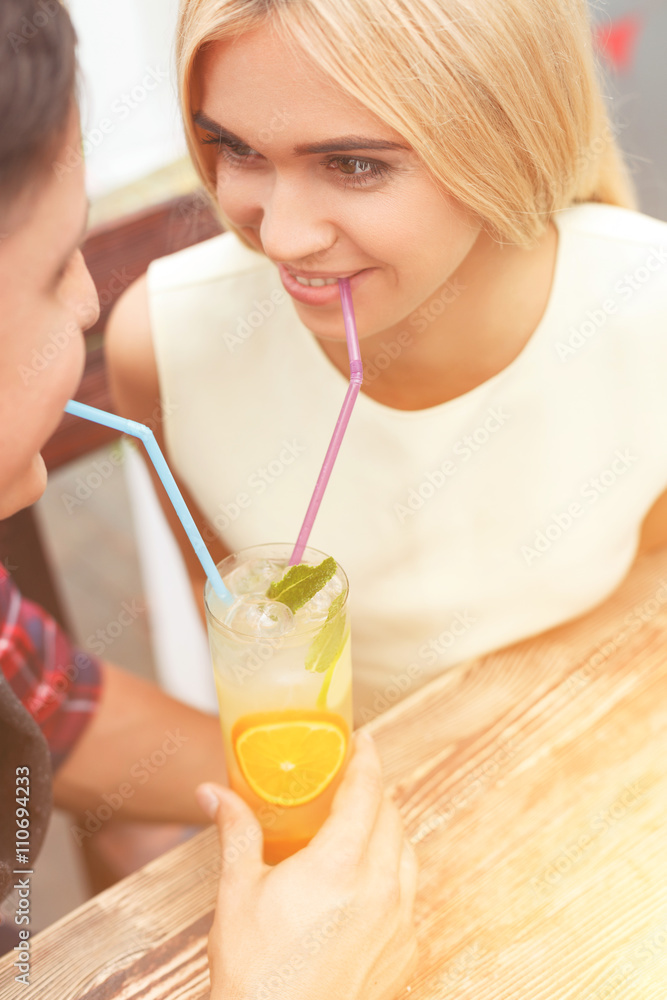 Cute loving couple is relaxing in cafe Cute loving couple is relaxing in cafe