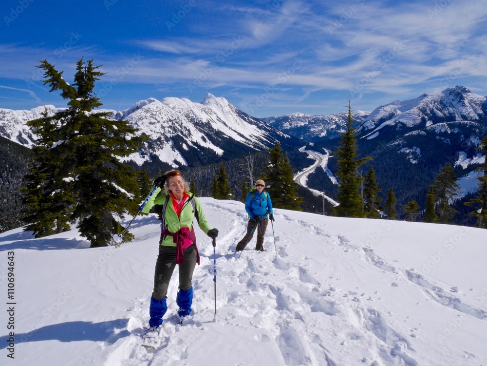 Two Women Snowshoeing in Mountains. 
Yago Peak, Coquihalla Summit Recreation Area near Hope, British Columbia, Canada. 