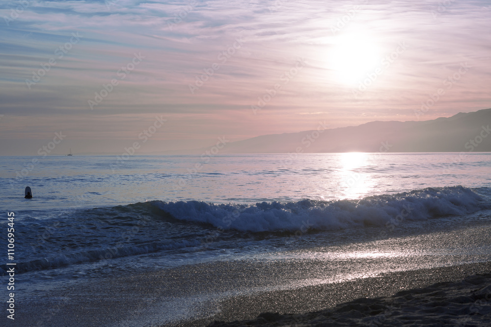 The Pacific ocean during sunset. Landscape with blue sea, the mountains and the dusk sky, the USA, Santa Monica. 