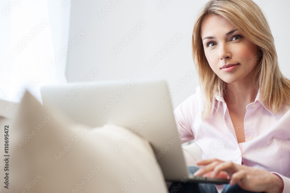 Pretty young woman is working on laptop Pretty young woman is working on laptop