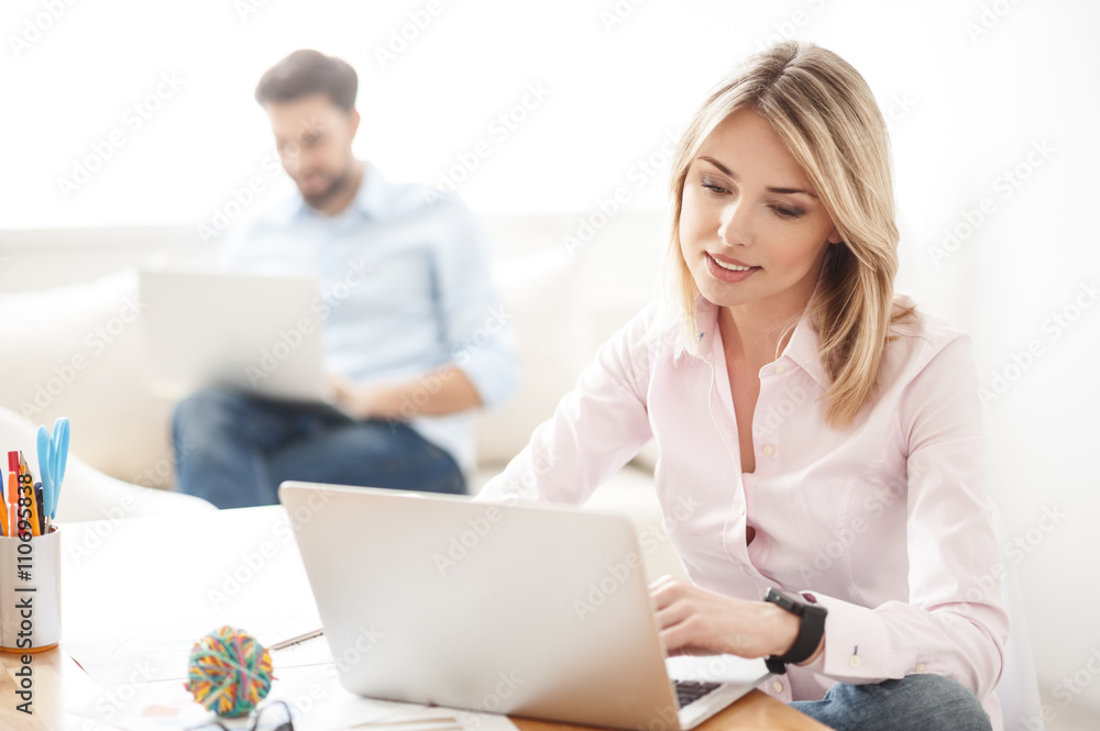 Skillful blond woman using computer for work Skillful blond woman using computer for work