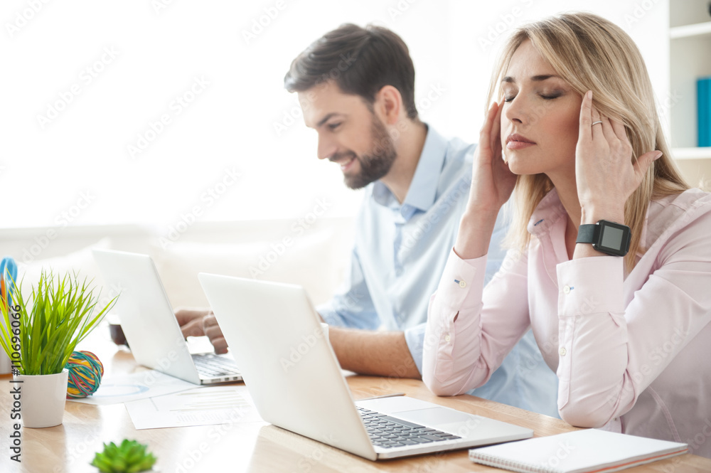 Pretty businesswoman has a terrible headache Pretty businesswoman has a terrible headache