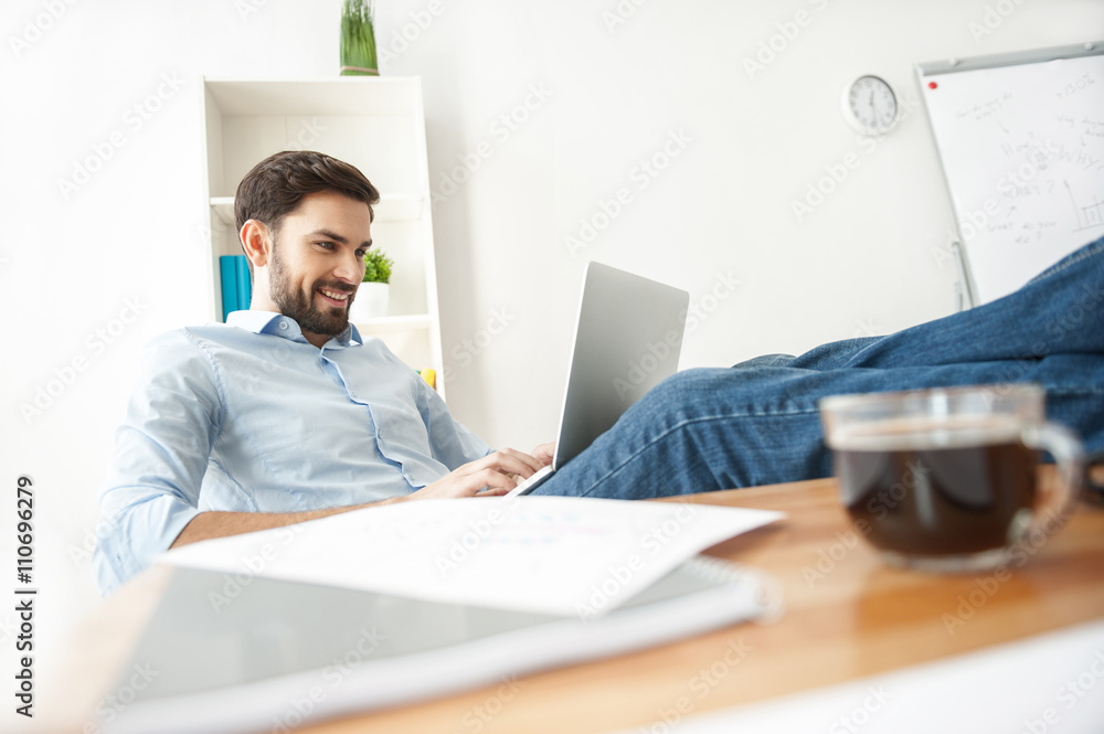 Skillful male worker is using a notebook Skillful male worker is using a notebook