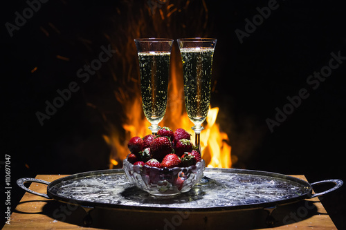 two glasses of champagne with flame on background photo