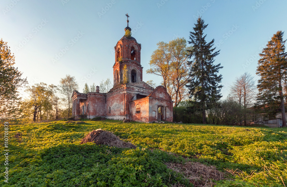 Abandoned brick orthodox church at sunset