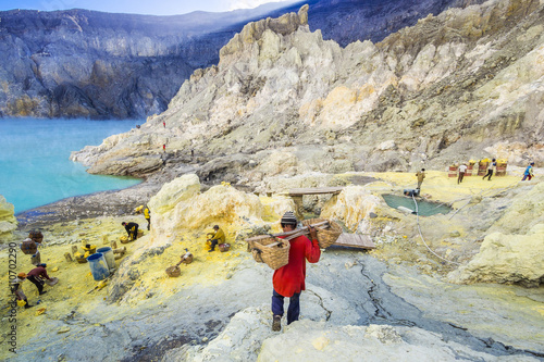 Sulfur miner hiking into the crater of Ijen volcano, East Java, Indonesia. photo