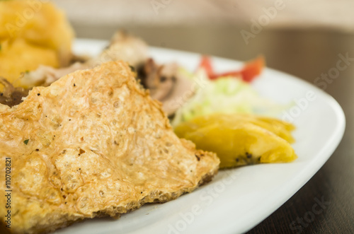 Traditional ecuadorian plate of pork hornado, elegant presentation on white plate, catering concept