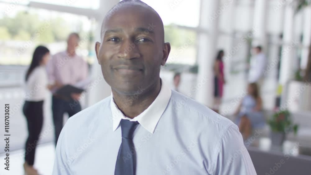 Portrait of confident smiling businessman in modern office building Portrait of confident smiling businessman in modern office building