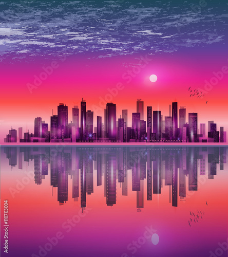 Modern night city skyline at sunset  with reflection on water surface