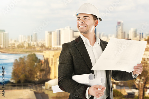 Architect in hardhat on blu...
