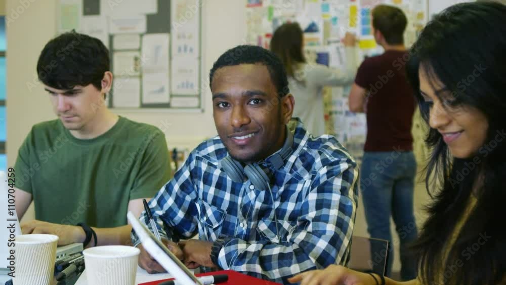 custom made wallpaper toronto digital Portrait of smiling male student working in class with other students