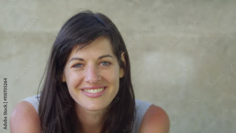 Candid portrait of beautiful woman smiling to camera outdoors in the city Candid portrait of beautiful woman smiling to camera outdoors in the city