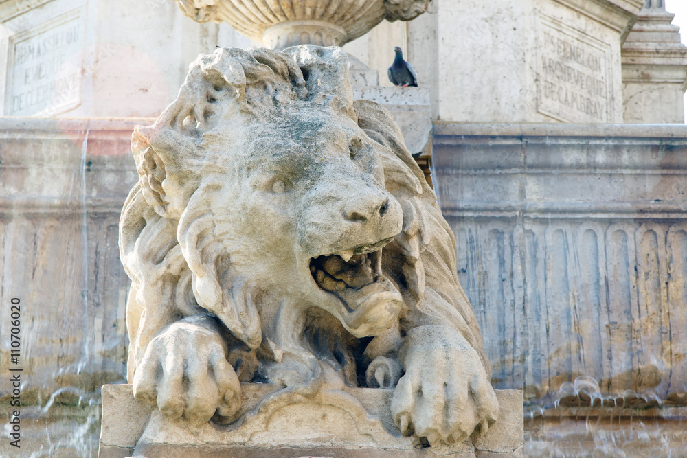 Carved stone lion in the fountain in the plaza fronting the Church of Saint Sulpice, Paris, France. 