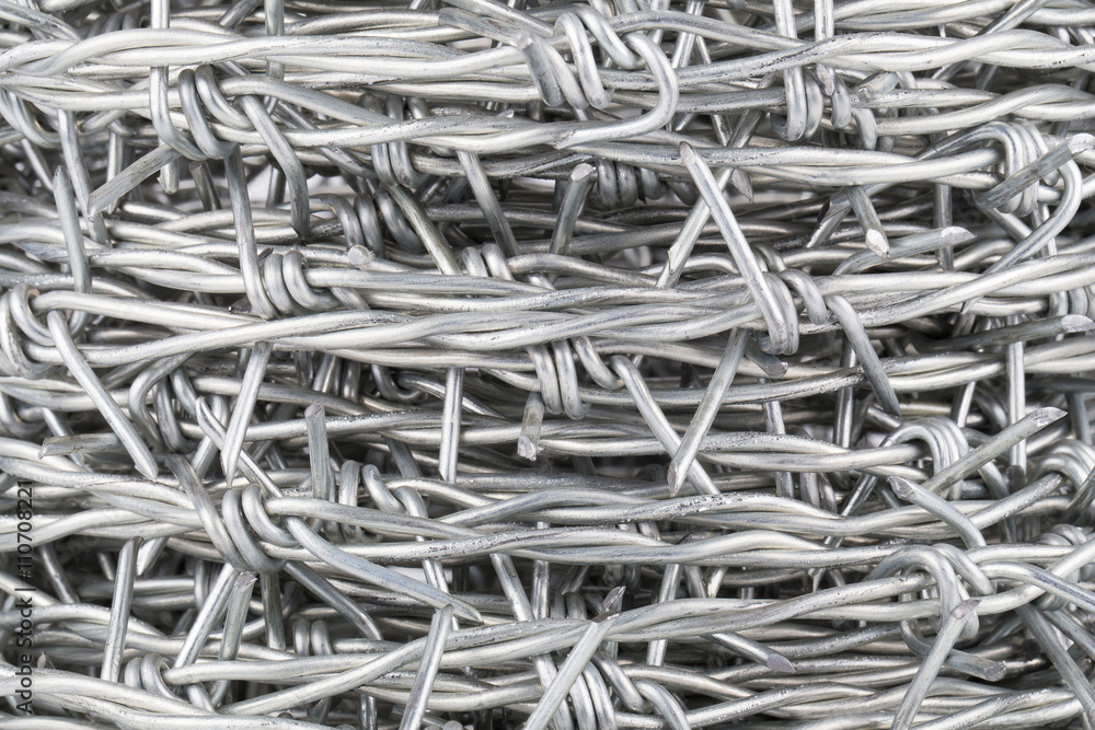 Roll up of barbed wire on white background