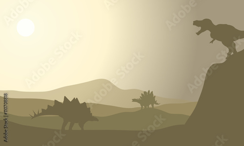 Silhouette of stegosaurus in desert