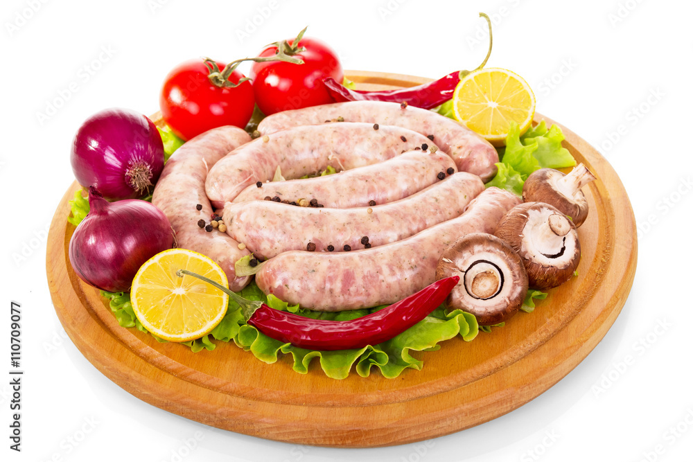 Uncooked sausages, vegetables and spices for grilling isolated on white. Uncooked sausages, vegetables and spices for grilling isolated on white.