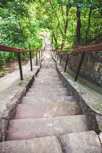 narrow stone staircase in summer park © glebchik