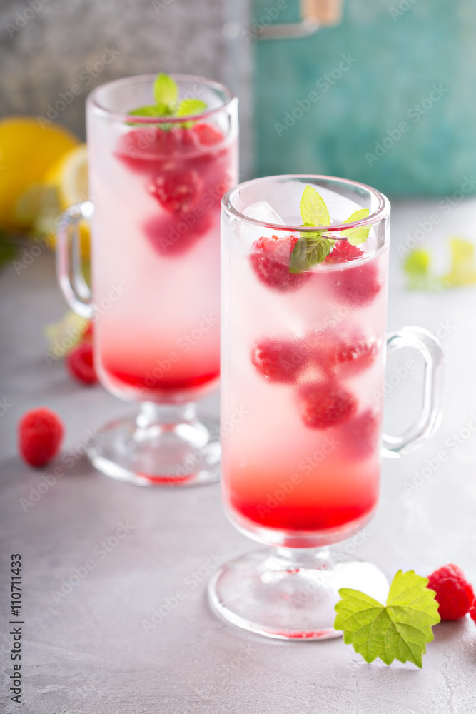 Pink raspberry lemonade in tall glasses Pink raspberry lemonade in tall glasses