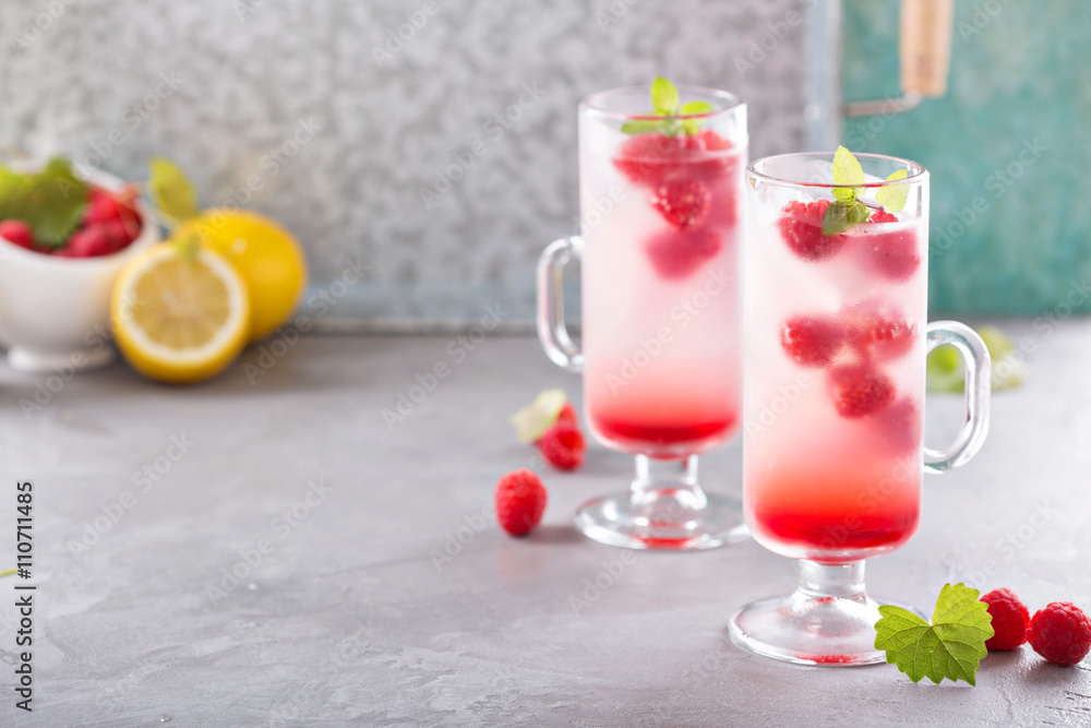 Pink raspberry lemonade in tall glasses Pink raspberry lemonade in tall glasses