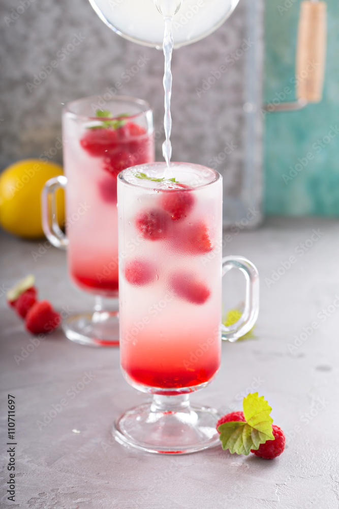 Pink raspberry lemonade in tall glasses Pink raspberry lemonade in tall glasses