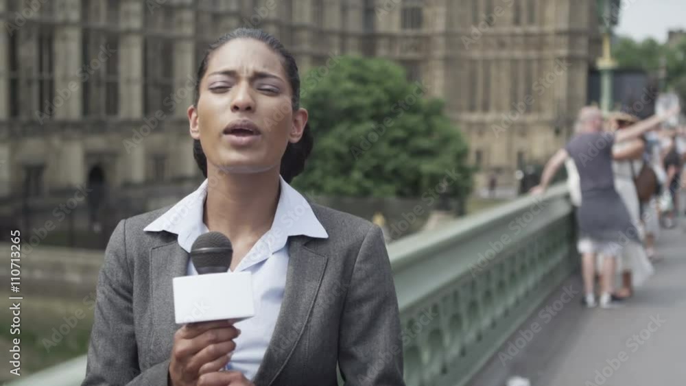  News reporter doing live piece to camera outside London Houses of Parliament