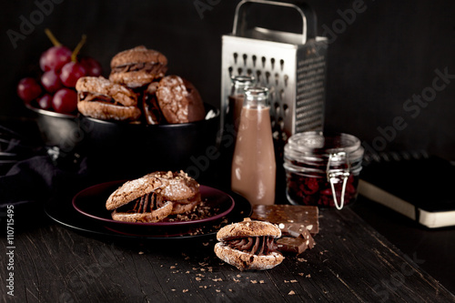 Christmas almond cookies and chocolate milkshake on dark wooden photo