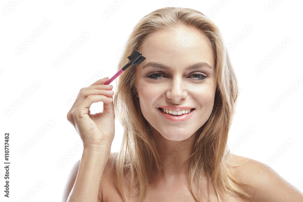 attractive blonde woman using eyebrows comb attractive blonde woman using eyebrows comb